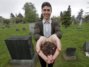 Katrina Spade, founder and CEO of Recompose, displays a sample of the compost material left from the decomposition of a cow, using a combination of wood chips, alfalfa and straw, as she poses in a cemetery in Seattle. Washington state is set to become the first state to allow the burial alternative known as 'natural organic reduction,' that turns a body into soil in a matter of weeks.