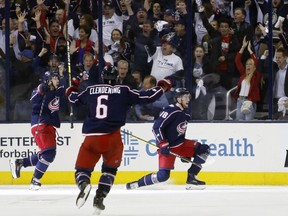 Blue Jackets' Pierre-Luc Dubois, right, celebrates his goal against the Lightning with teammates Oliver Bjorkstrand, left, and Adam Clendening during the first period of Game 4 of an NHL first-round playoff series, Tuesday, April 16, 2019, in Columbus, Ohio.
