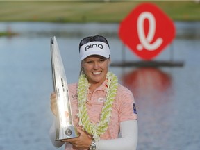 Canada's Brooke Henderson poses with the Lotte Championship trophy after winning the Lotte Championship of the LPGA Tour golf tournament at Ko Olina Golf Club in Kapolei, Hawaii, on Saturday, April 20, 2019.