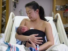 Lisa Wong demonstrates the "Joeyband" with newborn son Bruce Nagai in the maternity ward at St. Paul's Hospital in Vancouver.