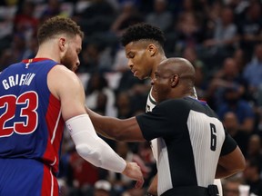 Referee Tony Brown (6) keeps Detroit Pistons forward Blake Griffin (23) and Milwaukee Bucks forward Giannis Antetokounmpo apart during the first half of Game 4 of a first-round NBA basketball playoff series, Monday, April 22, 2019, in Detroit.