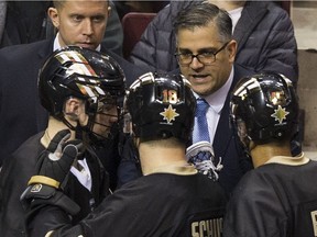 Vancouver Warriors head coach Chris Gill talks with players during a regular season NLL lacrosse game against the New England Black Wolves at Rogers Arena, Vancouver March 16 2019.