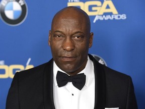 In this Feb. 3, 2018 file photo, John Singleton arrives at the 70th annual Directors Guild of America Awards in Beverly Hills, Calif. The "Boyz N the Hood" director suffered a stroke last week and remains hospitalized, according to a statement from his family on Saturday, April 20, 2019.
