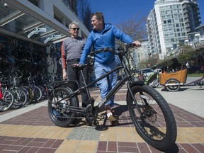 Paul Dragan (left), owner of Reckless Bikes, and humanitarian Stephen Sumner with a bike Dragan gave to Sumner to complete his mission to provide support to amputees in remote corners of the world. Photo: Jason Payne/Postmedia
