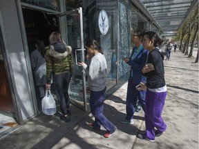 People wait for the opening of The Alley bubble tea shop on Hornby Street in Vancouver on April 24, 2019.