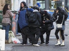 Residents congregate in Vancouver's Downtown Eastside in February 2019.