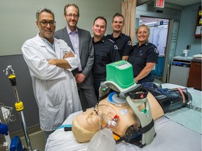 From left: Dr. Jamil Bashir, patient Chris Dawkins, 55, paramedics, Thomas Watson, Benjamin Johnson and dispatcher Anne-Marie Forrest at St. Paul's Hospital in Vancouver on April 8.