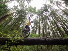 Ryan Kremsater one-wheeling on the North Shore trails near Braemar Park in North Vancouver.