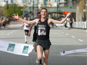 Justin Kent of Burnaby crosses the finish line first to win the 2019 Vancouver Sun Run in Vancouver on Sunday, April 14, 2019.