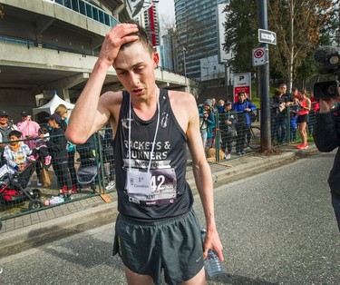Vancouver Sun Run winner Justin Kent of Burnaby gets a breather after crossing the finish line on Sunday, April 14, 2019.
