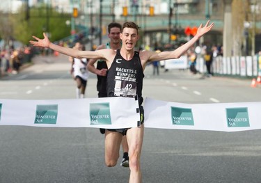 Burnaby's Justin Kent crosses the finish line to win the 35th annual Vancouver Sun Run in Vancouver on Sunday April 14, 2019.