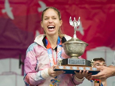 North Vancouver's Natasha Wodak is delighted to receive the trophy for being the first female to cross the finish line at the annual Vancouver Sun Run in Vancouver on Sunday, April 14, 2019.