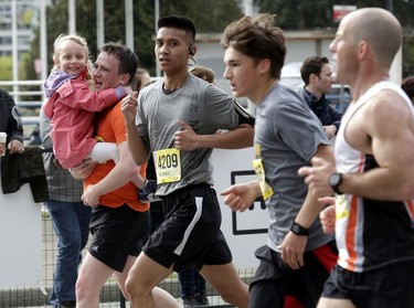 Vancouver Sun Run participants run hard — and, in this case, get a lift — during the 35th annual event in Vancouver on Sunday, April 14, 2019.