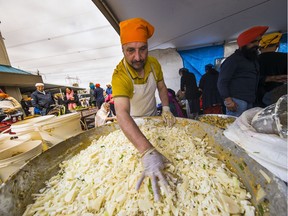 Plan to attend Saturday's Vaisakhi celebrations in Surrey on an empty stomach as free food is a big part of the annual Sikh harvest festival. Here, some of the volunteers are preparing food at the Gurdwara Dashmesh Darbar Temple.