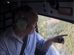 Premier John Horgan views the Philpot Road forest fire near Kelowna in August 2017. Horgan is giving the keynote speech to the 2019 B.C. Council of Forest Industries convention in Vancouver on Friday.