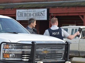 RCMP officers talk behind a barricade in front of the Salmon Arm Church of Christ in Salmon Arm, B.C. on Sunday, April 14, 2019. One person is in custody and one person was airlifted to hospital after a possible shooting in Salmon Arm, B.C. Salmon Arm RCMP say they are responding to a serious incident, which they say is a possible shooting, in the city, about 100 kilometres north of Kelowna.