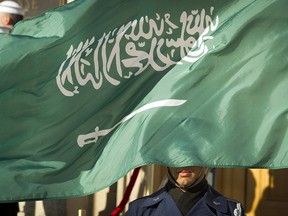 In this March 22, 2018 file photo, an Honor Guard member is covered by the flag of Saudi Arabia as Defense Secretary Jim Mattis welcomes Saudi Crown Prince Mohammed bin Salman to the Pentagon with an Honor Cordon, in Washington Saudi Arabiaís Interior Ministry said Tuesday, April 23, 2019, that 37 Saudi citizens have been beheaded in a mass execution that took place across various regions of the country. Saudi King Salman ratified the executions for terrorism-related crimes by royal decree.