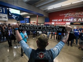 Vancouver Whitecaps fans gather on the B.C. Place Stadium concourse after leaving their seats during an in-game walkout protest to show support for members of the 2008 women's Caps and U20 Canadian teams who have alleged abuse by a former coach who ran both clubs, as the Whitecaps play the Philadelphia Union during the first half of an MLS match in Vancouver on April 27.