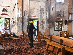 Security personnel inspect the interior of St Sebastian's Church in Negombo on April 22, 2019, a day after the church was hit in series of bomb blasts targeting churches and luxury hotels in Sri Lanka.