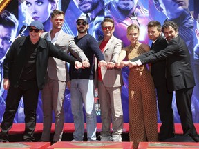 Marvel Studios President Kevin Feige, from left, poses with members of the cast of "Avengers: End Game," Chris Hemsworth, Chris Evans, Robert Downey Jr., Scarlett Johansson, Jeremy Renner and Mark Ruffalo at a hand and footprint ceremony at the TCL Chinese Theatre on Tuesday, April 23, 2019, in Los Angeles.