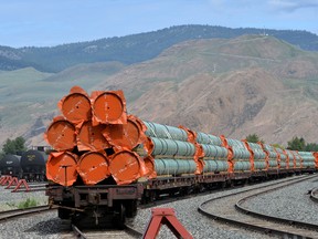 Steel pipe to be used in the Trans Mountain pipeline expansion on rail cars at a stockpile site in Kamloops, B.C.