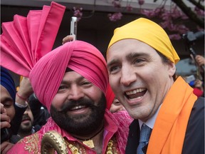 Prime Minister Justin Trudeau, right, poses for a photograph with Gurmukh Singh after marching in the Vaisakhi parade, in Vancouver on Saturday.