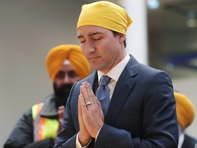 Prime Minister Justin Trudeau bows his head before speaking at the Khalsa Diwan Society Sikh Temple before marching in the Vaisakhi parade, in Vancouver on Saturday April 13, 2019. Vaisakhi is a significant holiday on the Sikh calendar, commemorating the establishment of the Khalsa in 1699 and marking the beginning of the Punjabi harvest year. THE CANADIAN PRESS/Darryl Dyck ORG XMIT: VCRD509