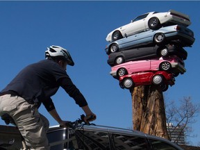 A cyclist rides past Trans Am Totem in 2015.