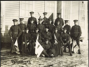 Leslie Miller was in the signal corps of the 32nd Battalion that fought at Vimy Ridge. In this group photo Miller is standing on the left holding two flags.