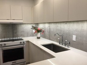 Malae Blakeley's condo features backsplash wallpaper to look like concrete.