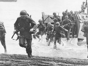 U.S. Marines charge ashore on Guadalcanal Island from a landing barge in August 1942, during the early phase of the U.S. offensive in the Solomon Islands during World War II. The dog tags of an American soldier missing from a World War II battle in the Pacific have been turned over to U.S. military officials, along with skeletal remains that could be his. A military aviation researcher from upstate New York and two relatives of Pfc. Dale W. Ross, of Oregon, were given his dog tags and a bag containing skeletal remains earlier this month on Guadalcanal.