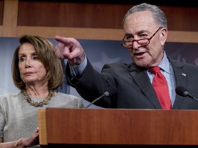 FILE - In this Jan. 25, 2019, file photo, Senate Minority Leader Sen. Chuck Schumer of N.Y., accompanied by Speaker Nancy Pelosi of Calif., left, calls on a reporter during a news conference on Capitol Hill in Washington. President Donald Trump and Pelosi and Schumer are coming together in search of a plan to fix the country's crumbling infrastructure. It's seen as the issue with the best chance for the two sides to work together _ though the odds aren't good.