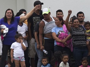 Migrants shout demanding better conditions or that they be transferred to another center, at an immigration detention center in Tapachula, Chiapas State, Mexico, Friday, April 26, 2019. At least 1,300 mainly Cuban migrants fled on foot from an immigration detention center on Mexico's southern border Thursday in the largest mass escape in recent memory.