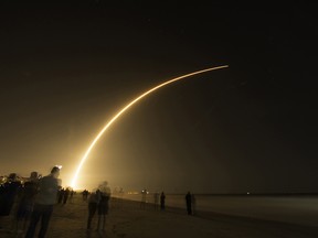 Spectators gather on the beach to watch a Space X launch from Cape Canaveral Air Force Station in Florida in 2018.