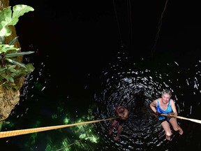 Lindsay Salt and her husband rappelling into a cenote.