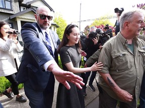 Huawei Technologies Chief Financial Officer Meng Wanzhou is escorted by security as she leaves her home on May 7, 2019 in Vancouver, Canada.