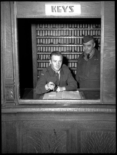 In January 1946, World War II veterans occupied the old and Hotel Vancouver, which was empty and slated for demolition, to draw attention to the city's acute housing shortage. Two men still in the Canadian army, Pte. S. Wardrope and S.-Sgt. D. R. MacDougall, act as desk clerk and hand out room keys to veterans on January 26, 1946.
