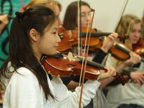 Students at the Langley Music School rehearsing on the fiddle for a performance. Photo: David Ediger