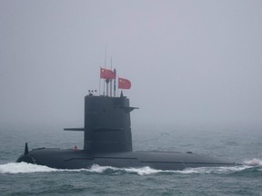 A Great Wall 236 submarine of the Chinese People's Liberation Army (PLA) Navy, billed by Chinese state media as a new type of conventional submarine, participates in a naval parade to commemorate the 70th anniversary of the founding of China's PLA Navy in the sea near Qingdao, in eastern China's Shandong province on April 23, 2019.