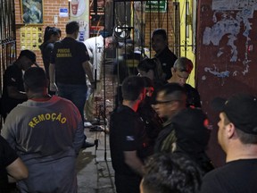 Forensic personnel and criminal police remove corpses from a bar in Belem, Para state, Brazil on May 19, 2019. - At least 11 people were shot dead Sunday at a bar in northern Brazil when unknown men opened fire, Para state Public Security Secretariat informed.