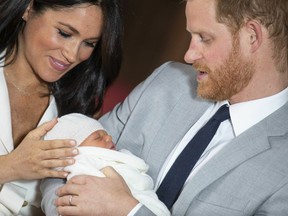 Prince Harry and Meghan, Duchess of Sussex, during a photocall with their newborn son, in St George's Hall at Windsor Castle, Windsor, south England, Wednesday May 8, 2019.