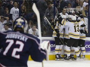 Boston Bruins players celebrate their goal against the Columbus Blue Jackets during the third period of Game 6 of an NHL hockey second-round playoff series Monday, May 6, 2019, in Columbus, Ohio.