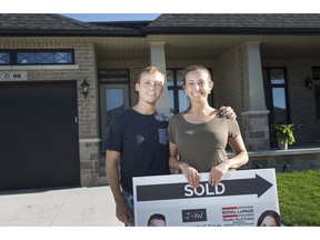 Andre Portovedo, left, and Danielle Bacci, who moved away from the Toronto area in January 2019, pose for a portrait in front of their new home in Kingsville, Ont., Thursday, May 23, 2019.