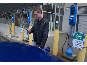 Byron Heslop disconnects charging his 2020 Kai Soul EV at the Hillcrest Aquatic centre in Vancouver in preparation for a trip to Whistler on May 25, 2019. (Gerry Kahrmann/ PNG FILES)