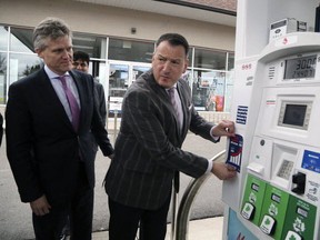 Greg Rickford, Minster of Energy, Northern Development and Mines, with an example of a sticker for gas pumps unveiled during a press conference on federal carbon taxes. Rickford says his fight against high gas prices in the northwest isn't over.
