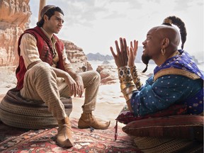 This image released by Disney shows Mena Massoud as Aladdin, left, and Will Smith as Genie in Disney's live-action adaptation of the 1992 animated classic "Aladdin." (Daniel Smith/Disney via AP) ORG XMIT: NYET207