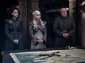 This image released by HBO shows from left, Nathalie Emmanuel, Emilia Clarke and Conleth Hill in a scene from "Game of Thrones," that aired Sunday, May 5, 2019. "Game of Thrones" fans got a taste of the modern world as the fictional series winds down to its final episodes. Eagle-eyed viewers Sunday spotted a takeout coffee cup on the table during a celebration in which the actors drank from goblets and horns. Daenerys and Jon did not react to the out of place cup.