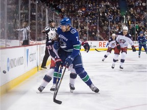 Luke Schenn checks Columbus Blue Jackets' Boone Jenner during first period of March 24, 2019 NHL game at Rogers Arena.