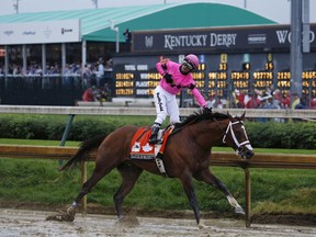 Jockey Luis Saez rides atop Maximum Security after crossing the finish line during the 145th running of The Kentucky Derby at Churchill Downs in Louisville, Kentucky, U.S., on Saturday, May 4, 2019. Country House won the 145th edition of the Kentucky Derby on Saturday after the horse that crossed the line first was disqualified.