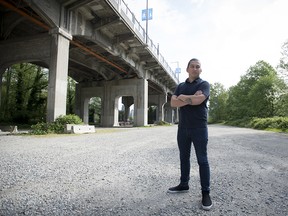 Dustin Rivers, or Khelsilem, stands on the land below and next to the Burrard Street Bridge where the Squamish Nation is proposing a massive housing project in Vancouver on May 1, 2019.
